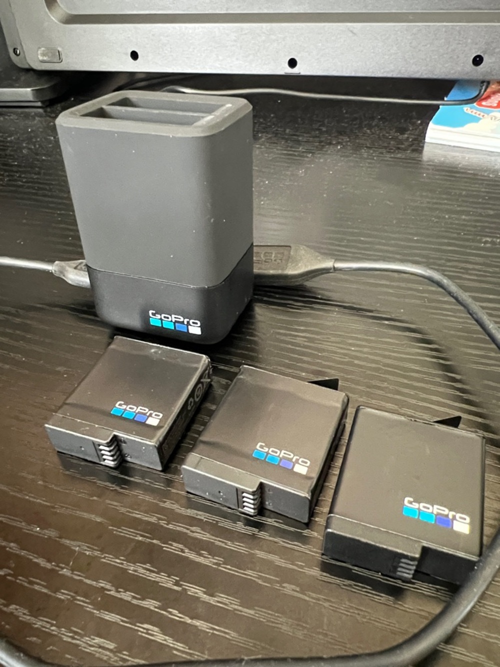 GoPro Dual Battery Charger and Three Black GoPro Batteries